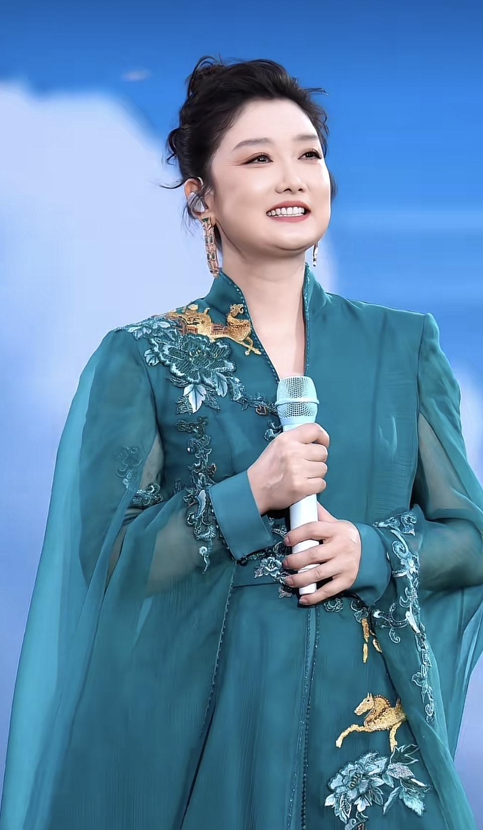 优雅女神，蓝绿色长裙，手持麦克风，闪耀舞台！