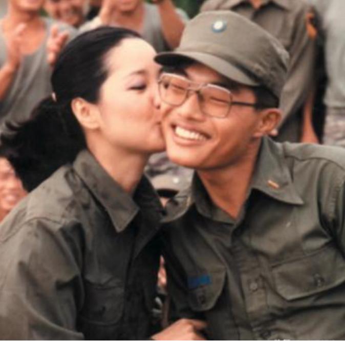 这是邓丽君在部队劳军时，摄影师拍下其亲吻士兵的精彩瞬间。士兵薛进友后来接受采访时