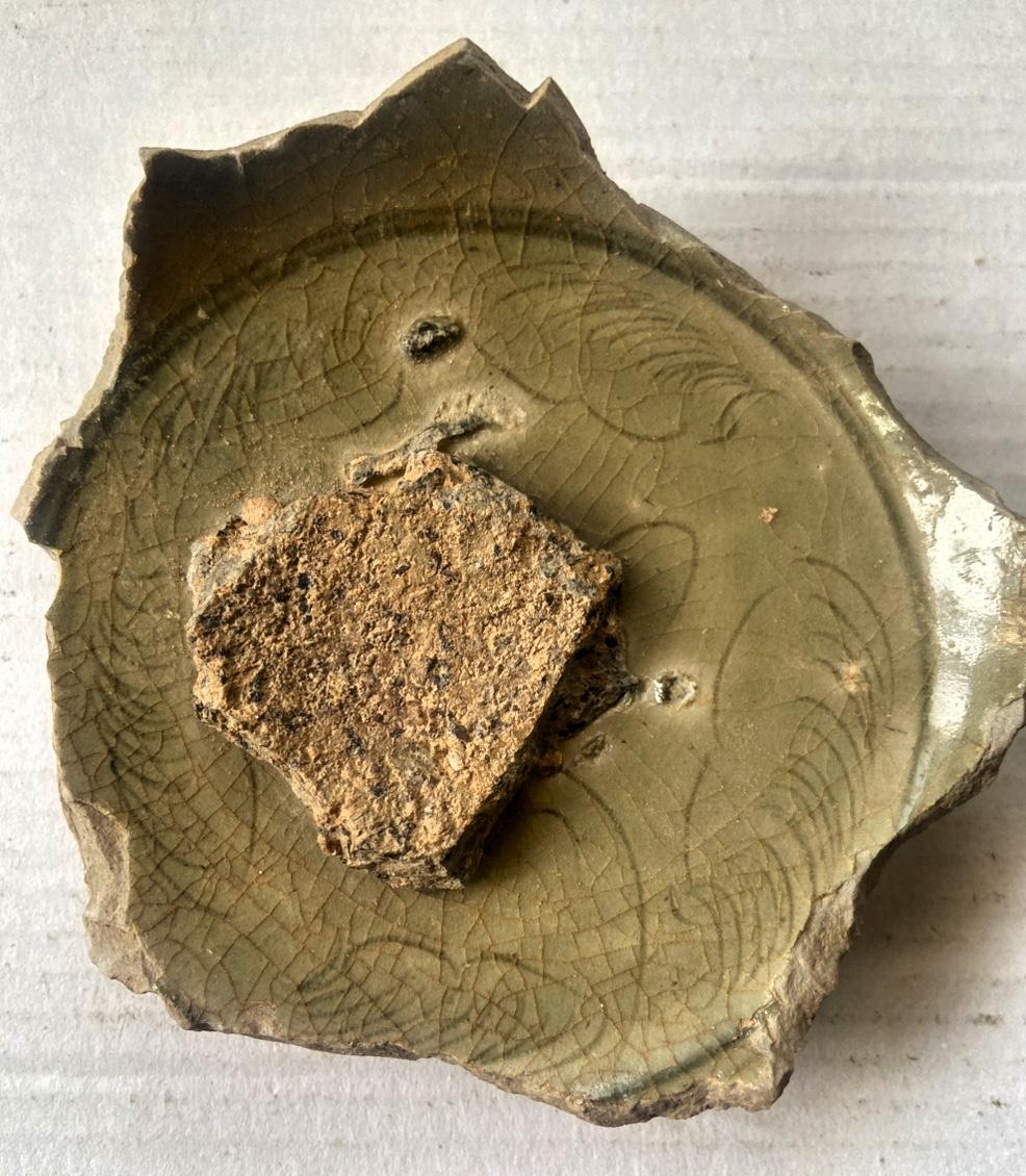 这件瓷片上的纹饰，是典型的越窑“卷草/云气纹”，采用刻划花工艺，线条流畅婉转，是