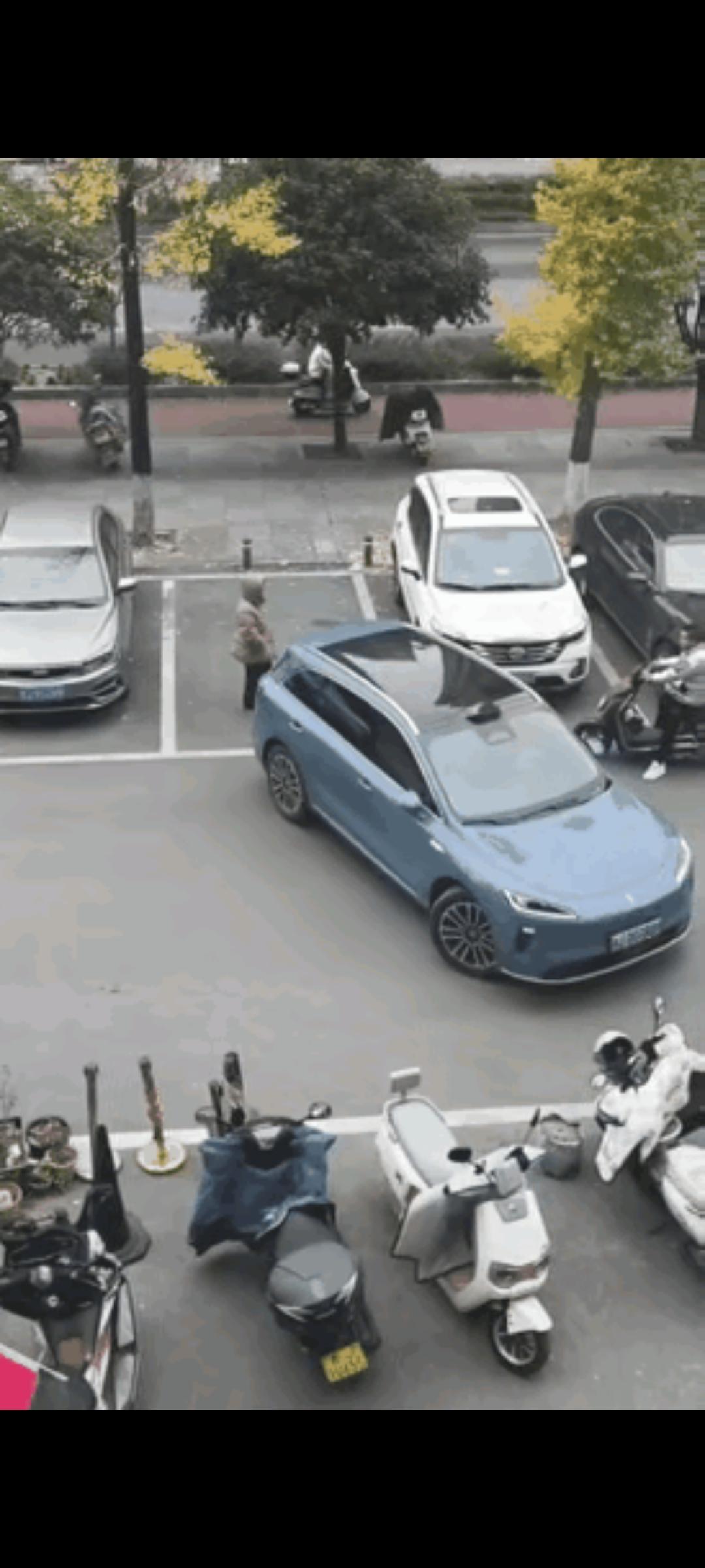 女子人肉占车位，小车司机也没跟她吵，就把车往车位前一停，人就径直离开了，女子一想