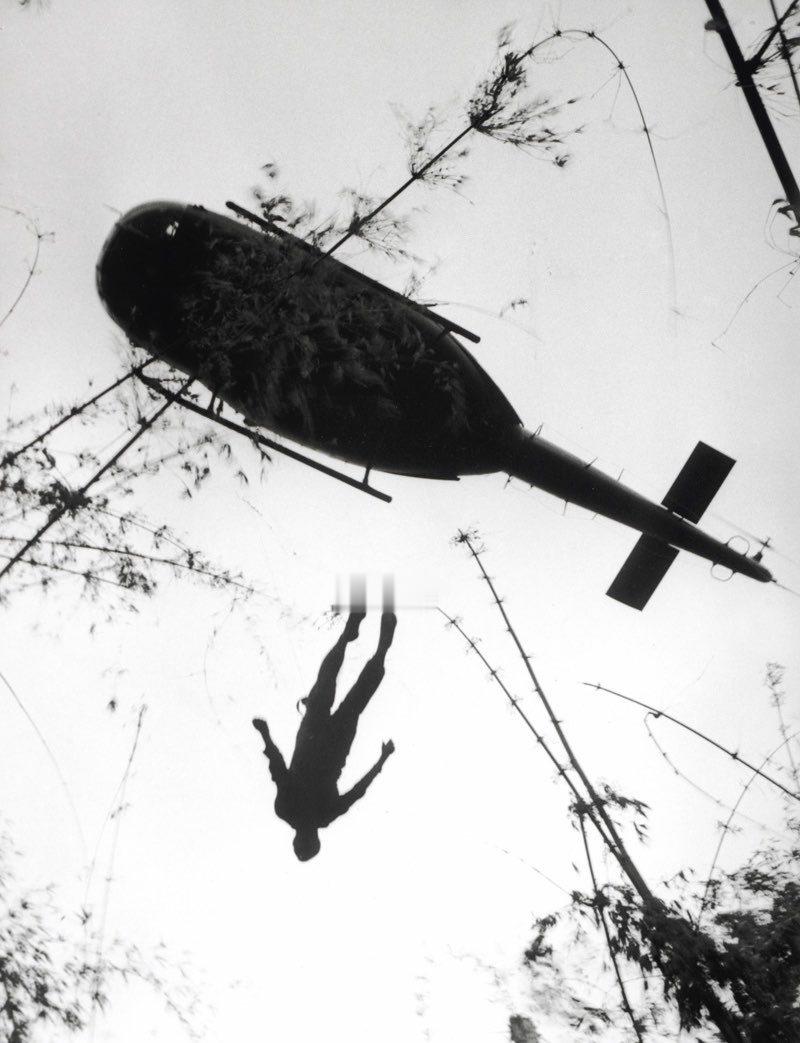 1966年，越南，一名在柬埔寨边境附近丛林中阵亡的美国伞兵遗体被抬上救援直升机。