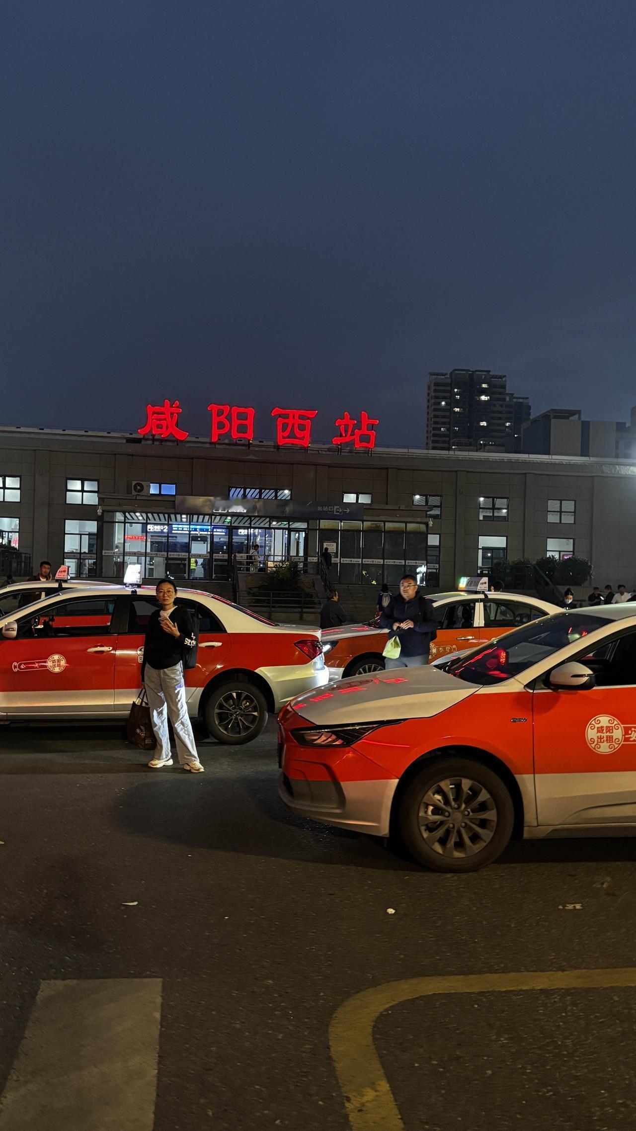 咸阳西站南广场能进出站，傍晚时分看见这么多旅客出站，站外也有很多人在接站，一派繁