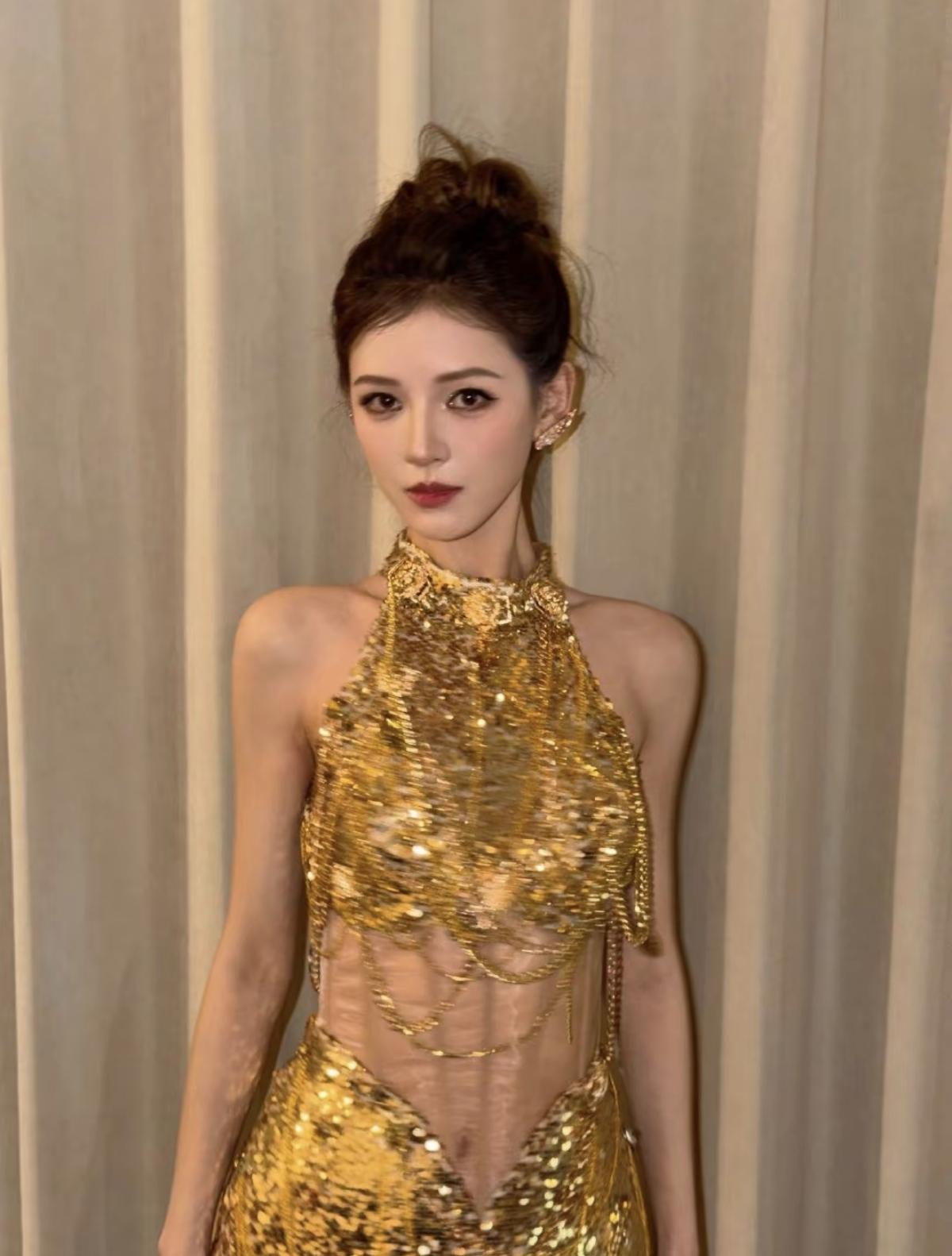 张予曦这套金色战袍直接封神！鎏金亮片缀满挂脖礼服，腰腹透视+链条设计勾勒出绝好身