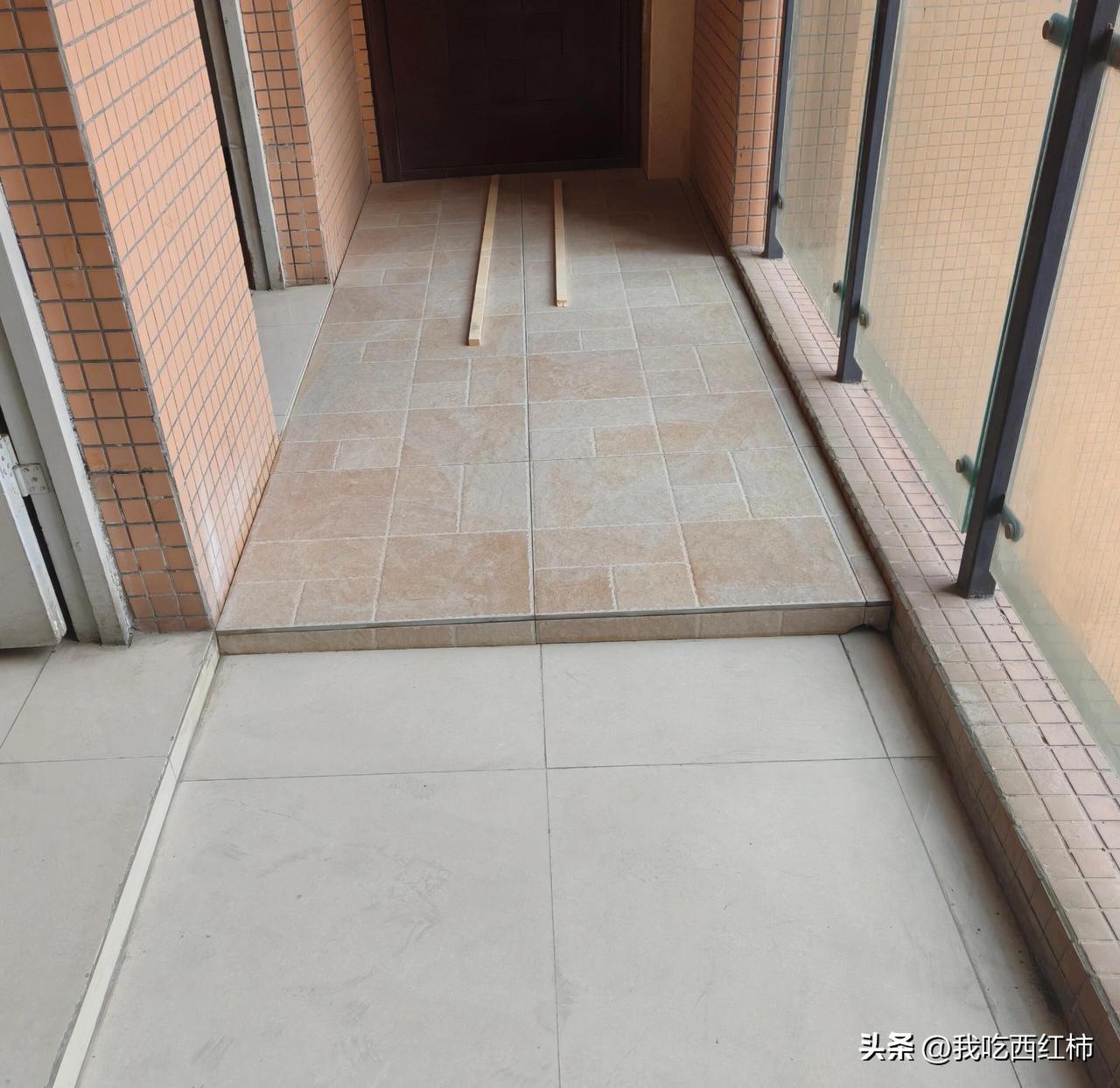 对面邻居在入户走廊铺地砖抬高
旁边是无遮挡的玻璃围栏，走廊地漏在他们家门口，这是