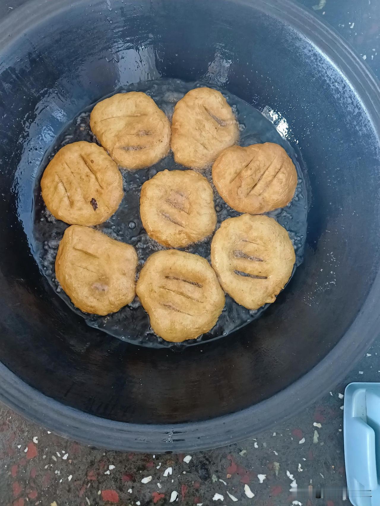 早上最爱吃家里炸的油饼，面团提前发好，揉得软乎乎的。擀成薄饼，中间划两道口子，往