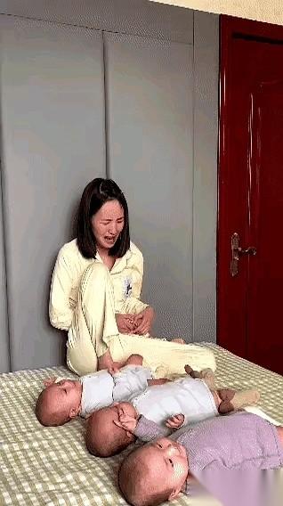 床上，三个娃跟商量好了似的，一个接一个开始哼唧。
年轻妈妈的脑袋“嗡”一下，抱着