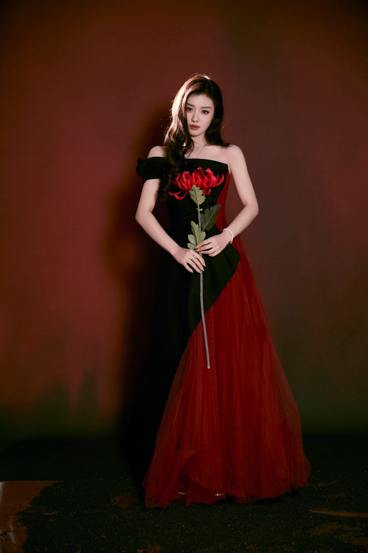 王鹤润暗夜彼岸花  今日活动造型图好美。一袭红黑纱裙在光影下魅惑动人，眼神冷冽，