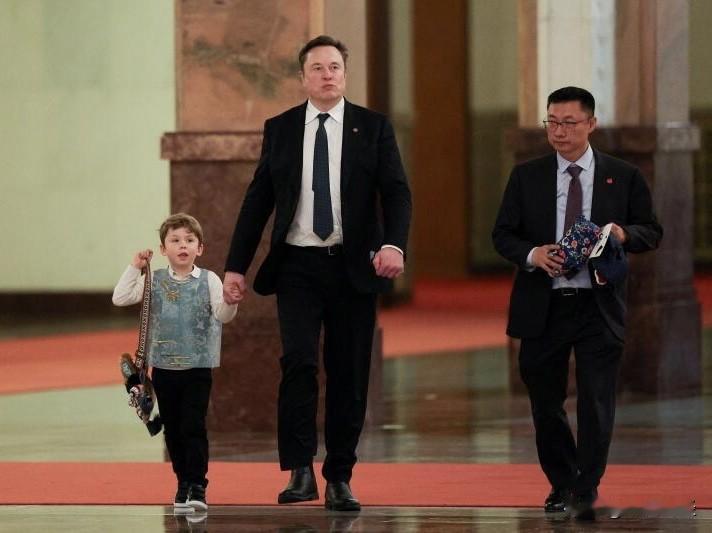 路透社最近流出的几张照片，捕捉到了马斯克这次访华行程里挺有意思的一幕。这位科技大