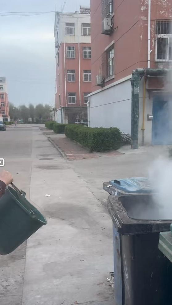 小区里，有人用柴火灶烧开水，完事后，柴灰里还有火星，就倒进了垃圾箱，火星借助风势