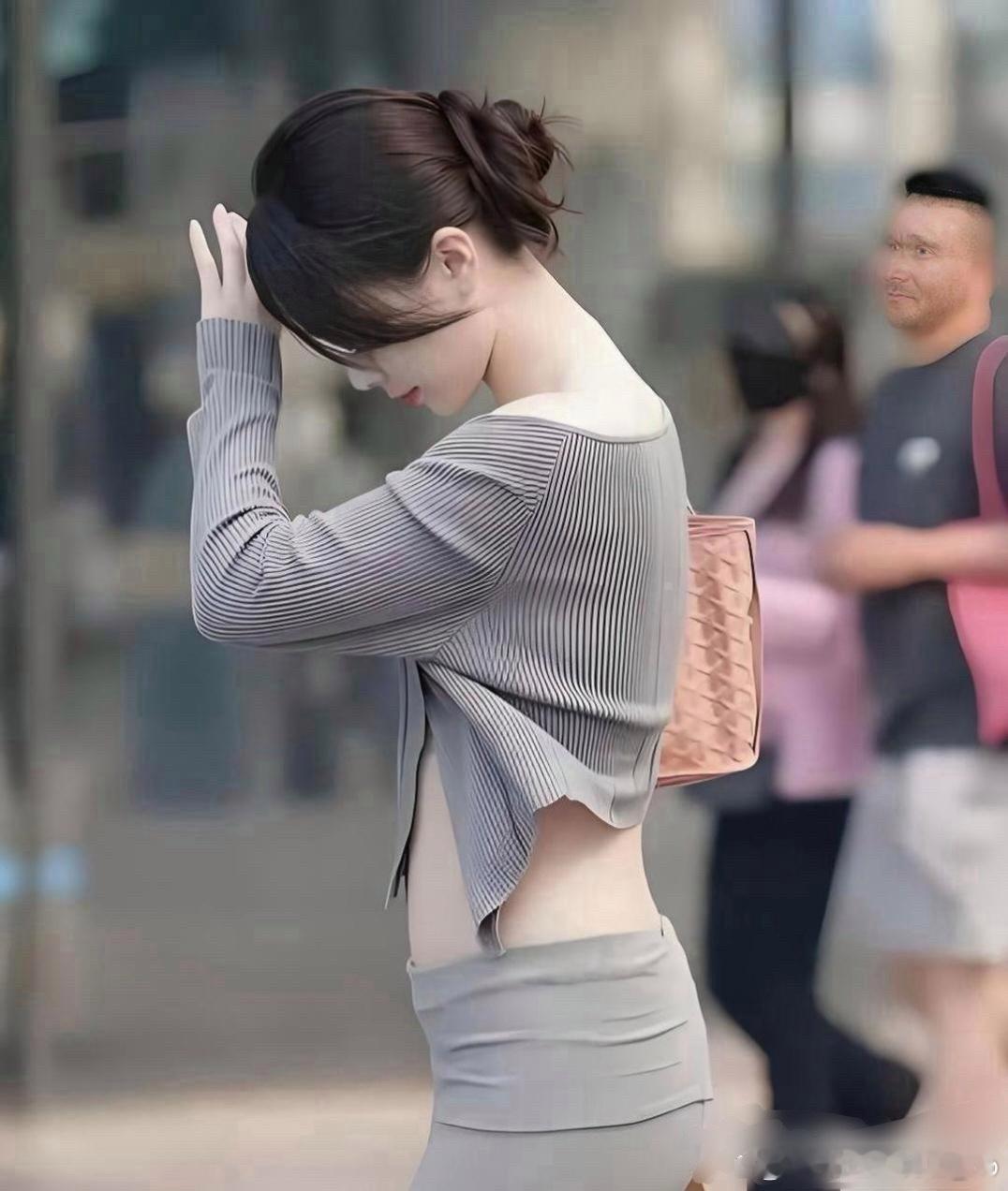 在北京街头碰到一位精致的女生，一身浅灰色穿搭，简约又显身材。随意挽起的发髻看着干
