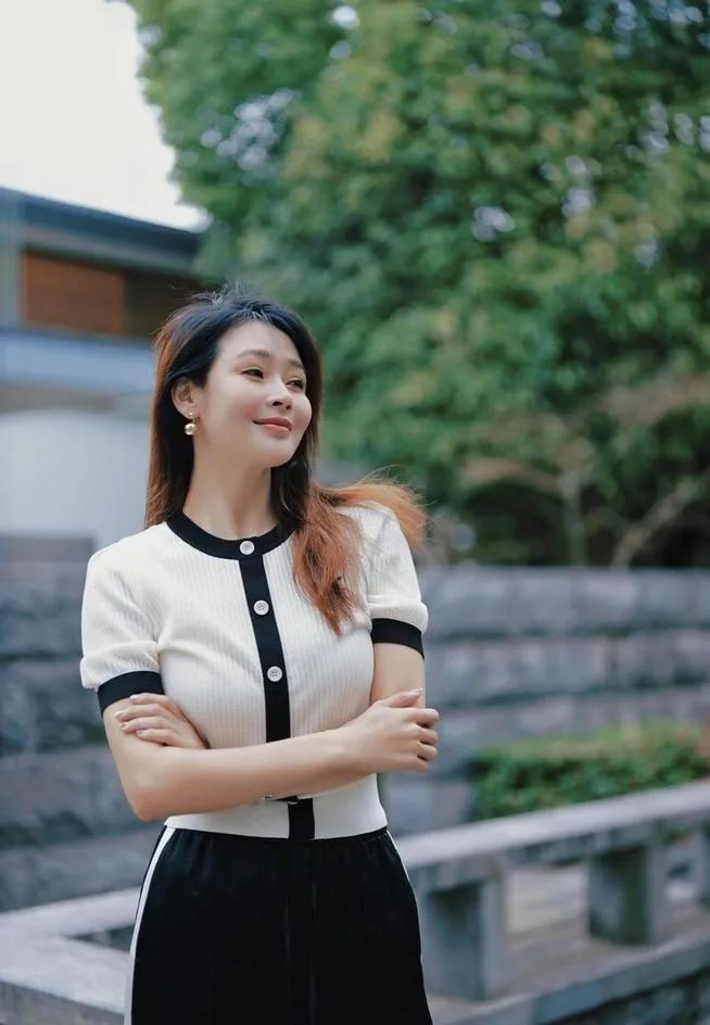 谁懂啊！于明加的穿搭真的太懂中年女人了！
一件黑白拼色的小香风针织短袖，搭条黑裤