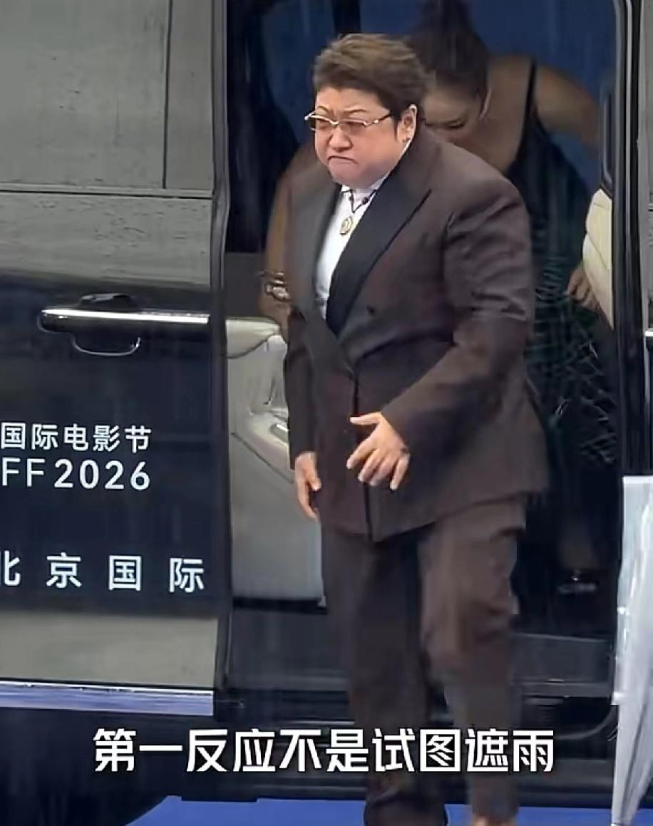 韩红和高叶一同出席北京国际电影节，现场下着瓢泼大雨，韩红下车后紧皱眉头，立刻转身