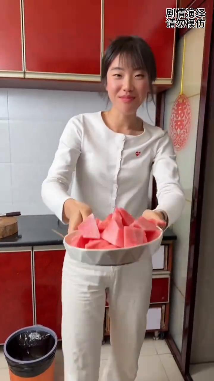 女子把西瓜嚷给丈夫吃，谁知她却吃的西瓜皮。
丈夫打开厨房门，然后她看到媳妇蹲着吃