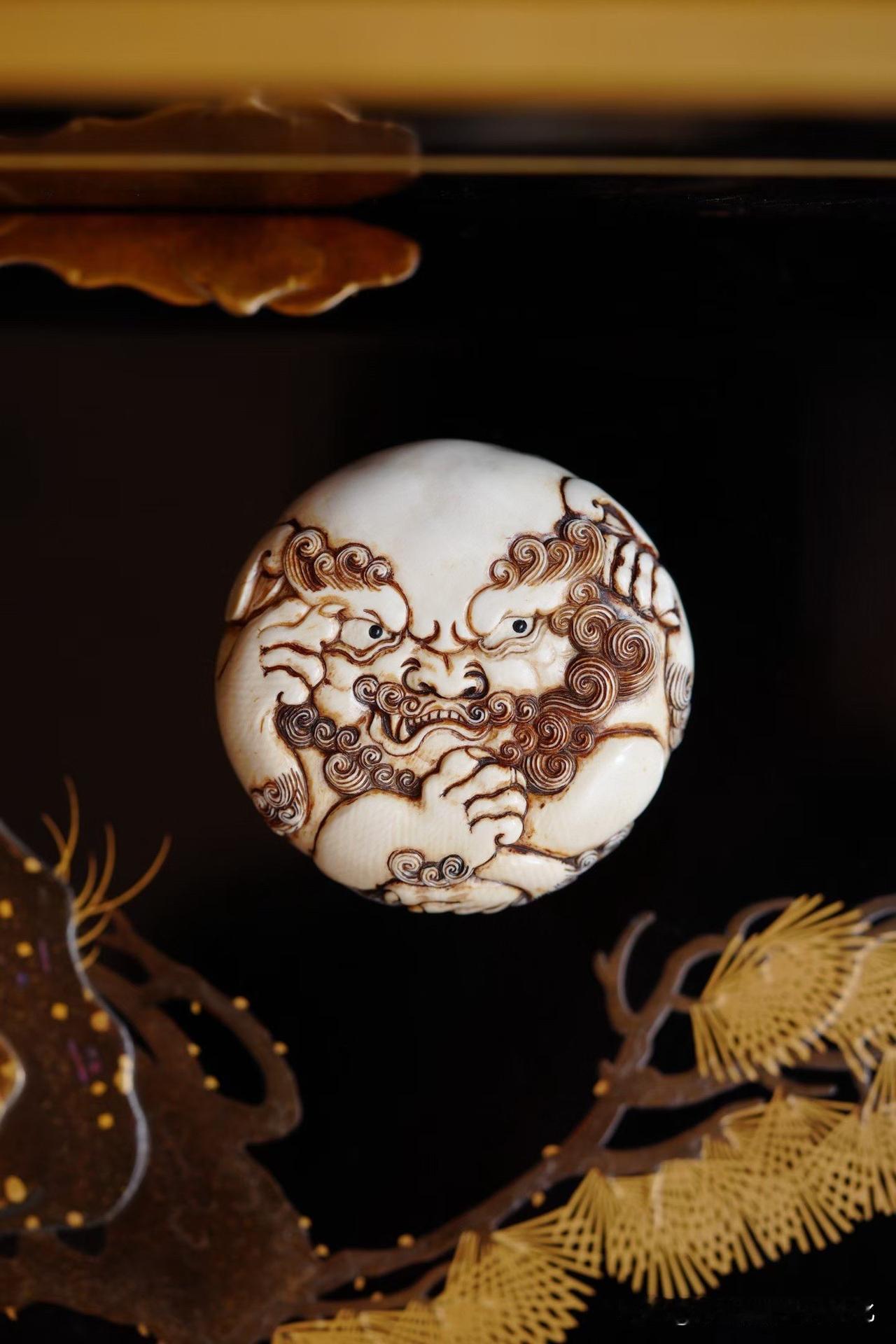 一头小狮，抱球而戏，威猛之中又透着几分俏皮。

足爪劲健，身姿辗转，雕刻随着形体