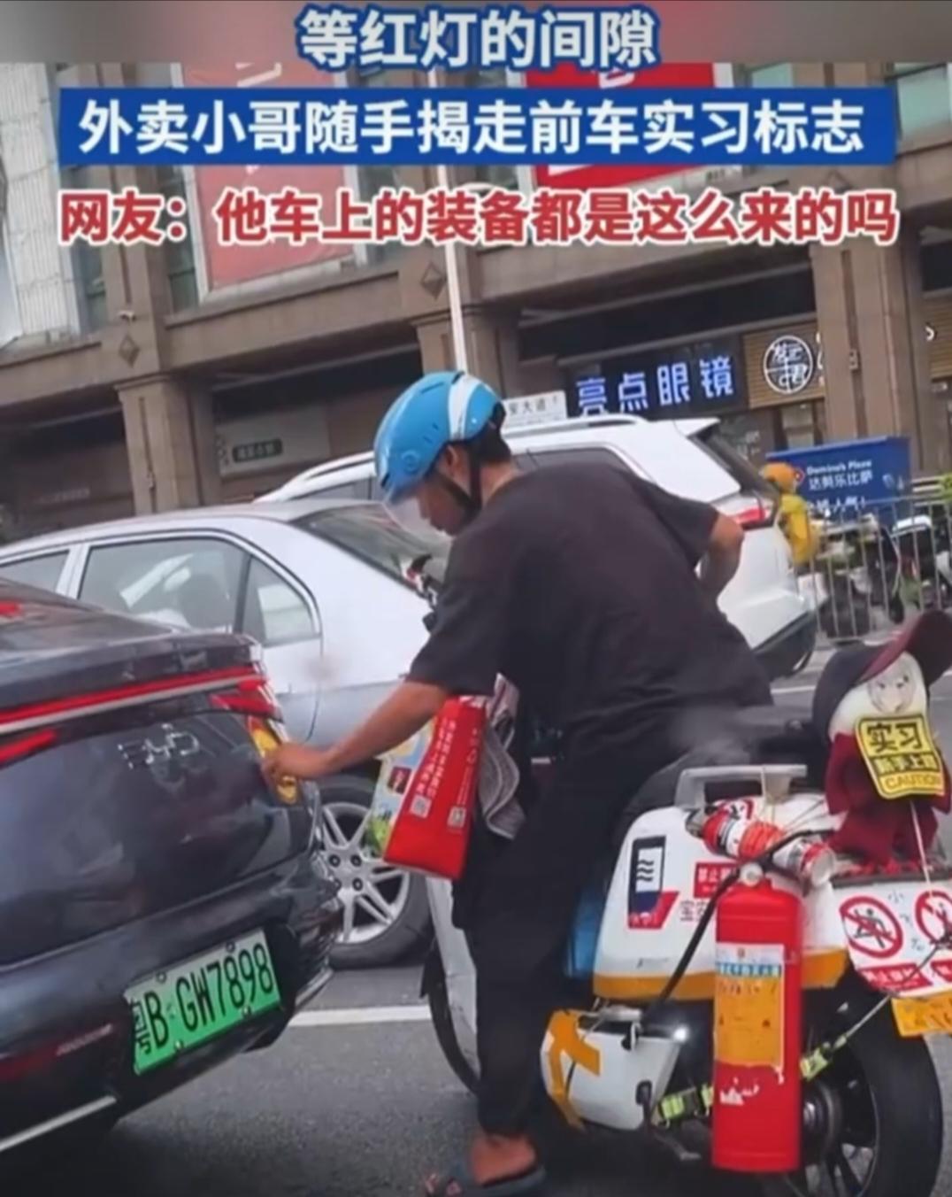 等红灯时外卖小哥“顺走”前车实习标，网友笑喷：他车上装备都是这么来的吗？

今天
