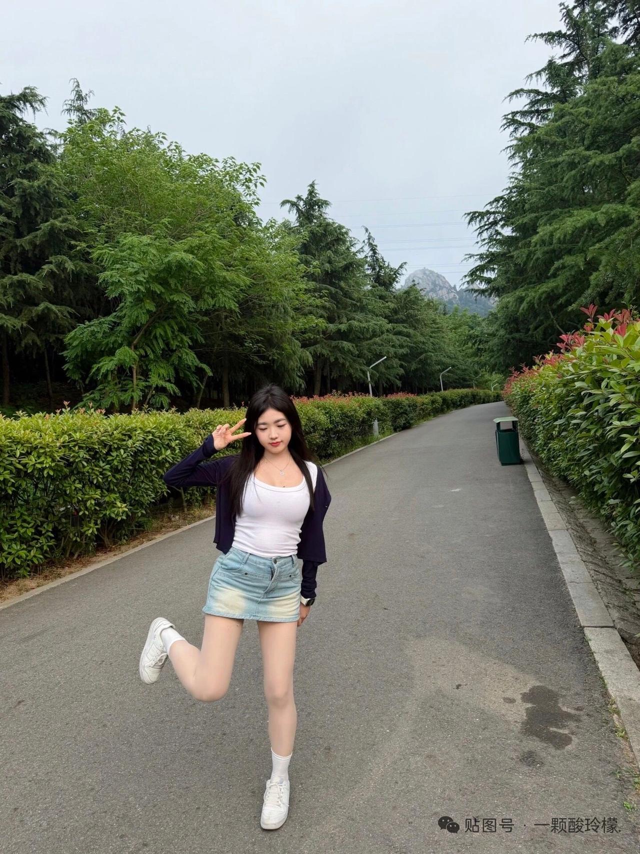 女孩在公园小路上摆姿势拍照。