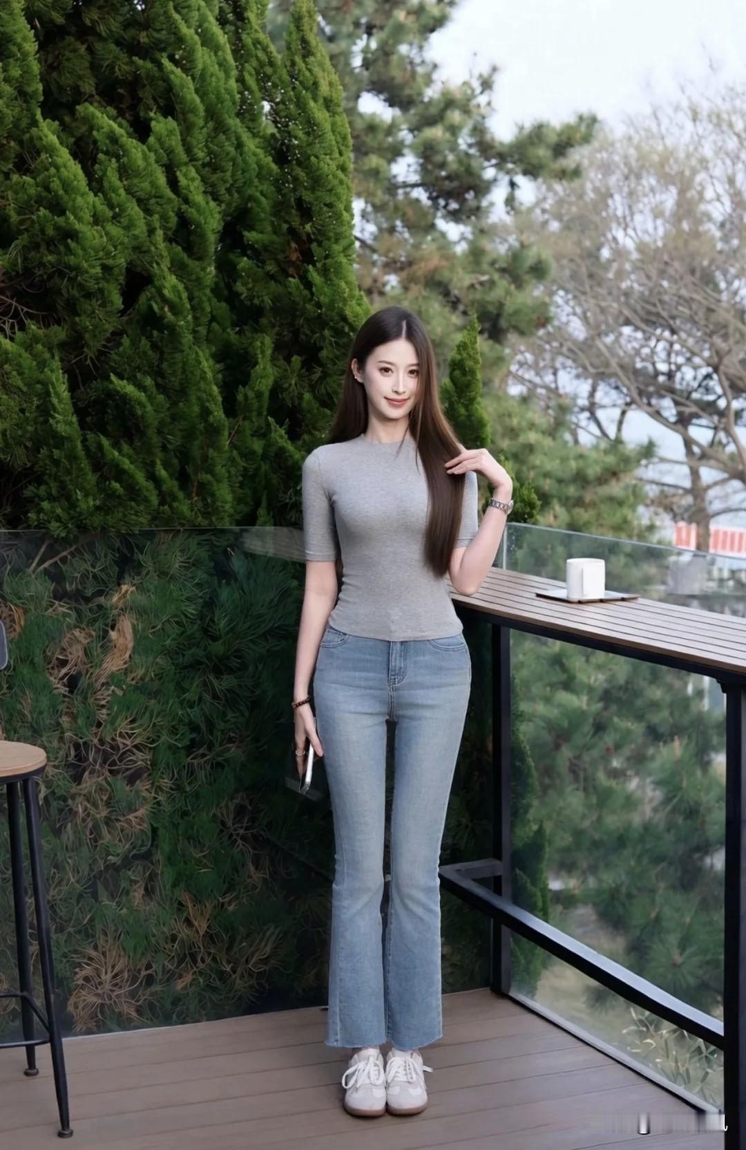 前两天上街，碰见一个姑娘在拍照片。

她穿了一件灰T恤和牛仔裤，就是很普通的打扮