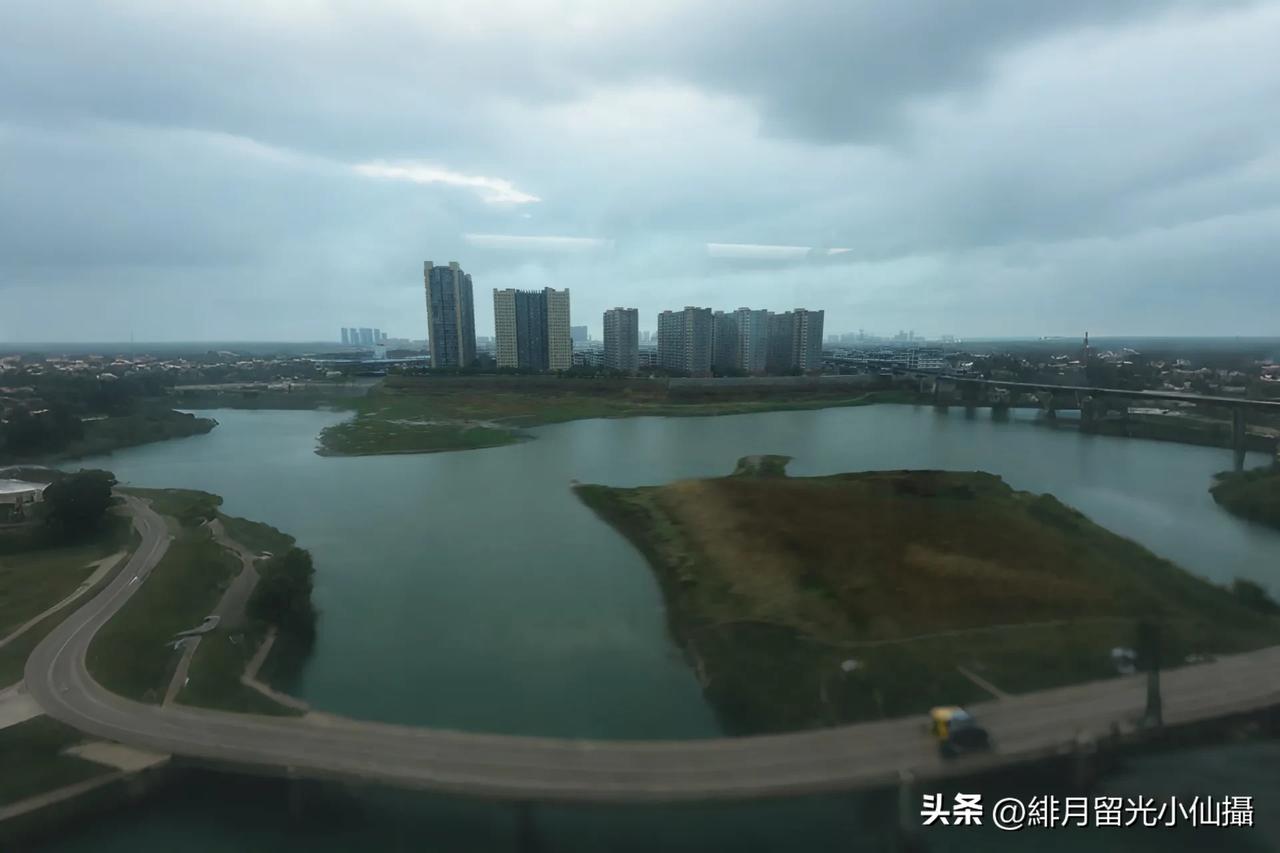 城市中的静谧水域别样风光，大片的水域在城市的一角静静流淌，周围还有蜿蜒的道路。