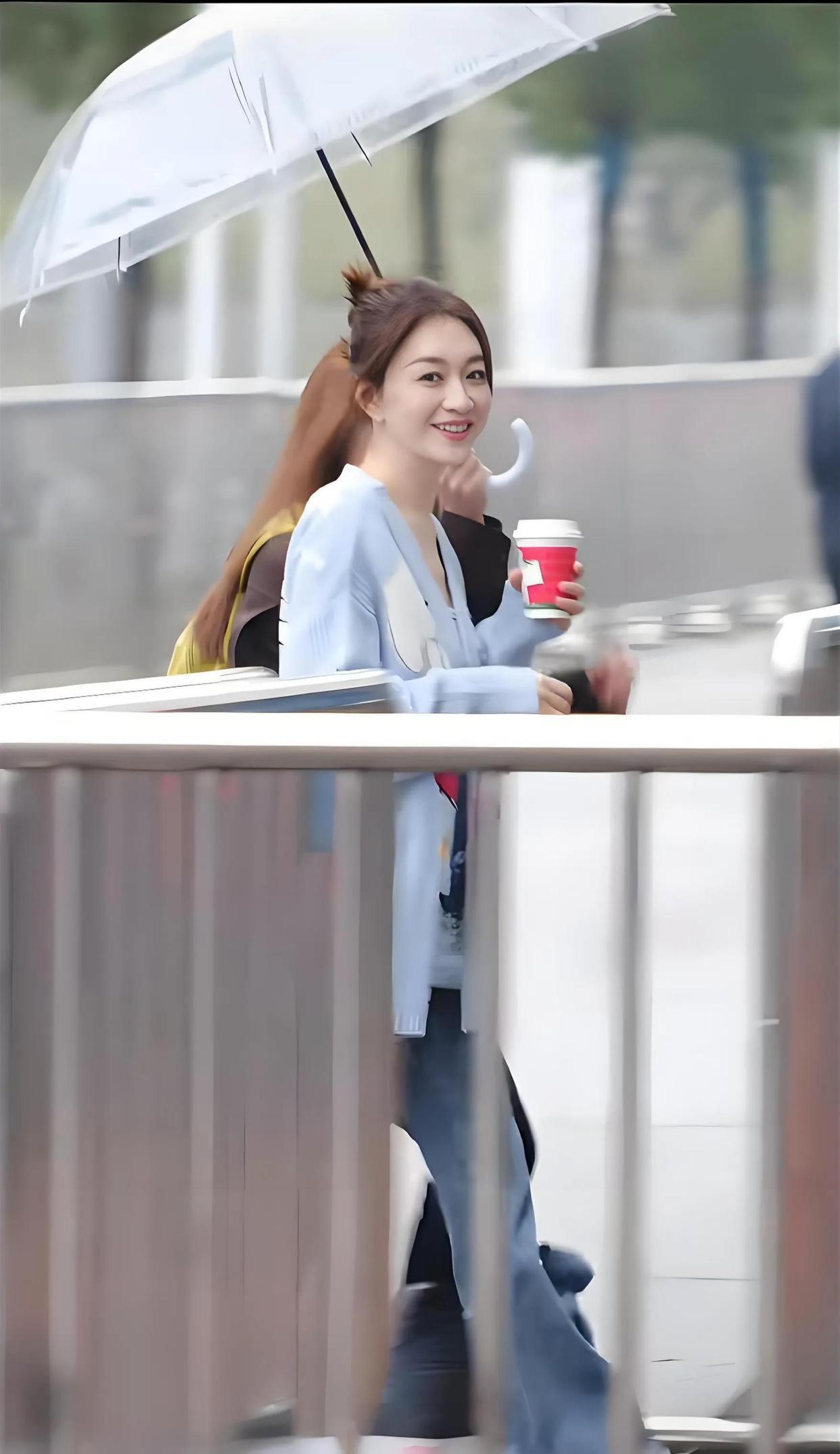 50岁的李小冉‌在湖南长沙一家便利店被路人偶遇，她身穿浅蓝色大V领针织衫搭配牛仔