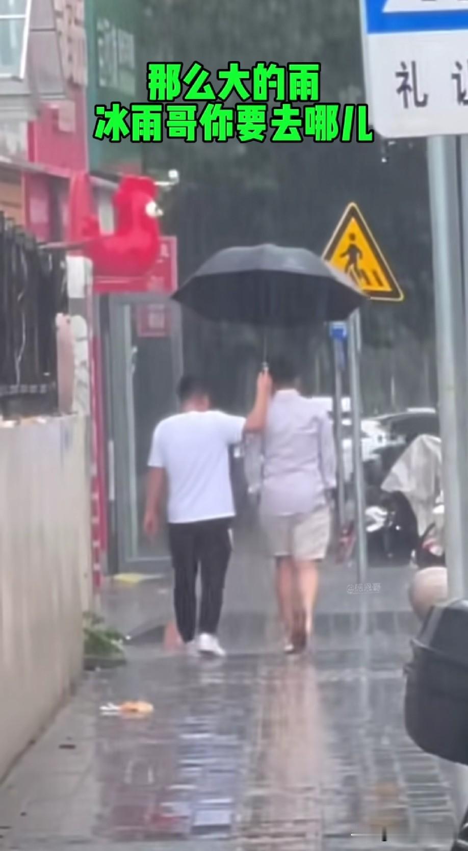网友偶遇“冰雨哥”汪小菲，雨下的好大，他家的司机小秦给他撑伞，汪小菲双手插兜，虽