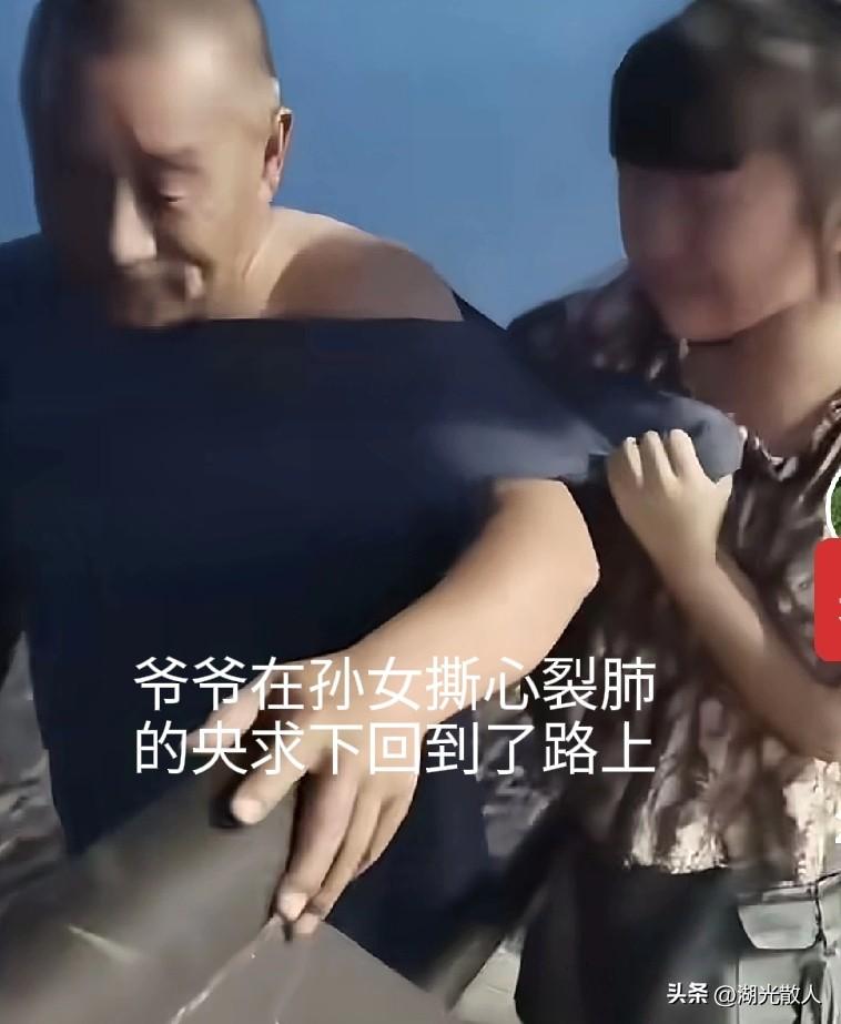 爷爷翻过护拦去捡孙女落下去的玩具，被孙女薅住衣服制止，孙女撕心裂肺地央求爷爷：不