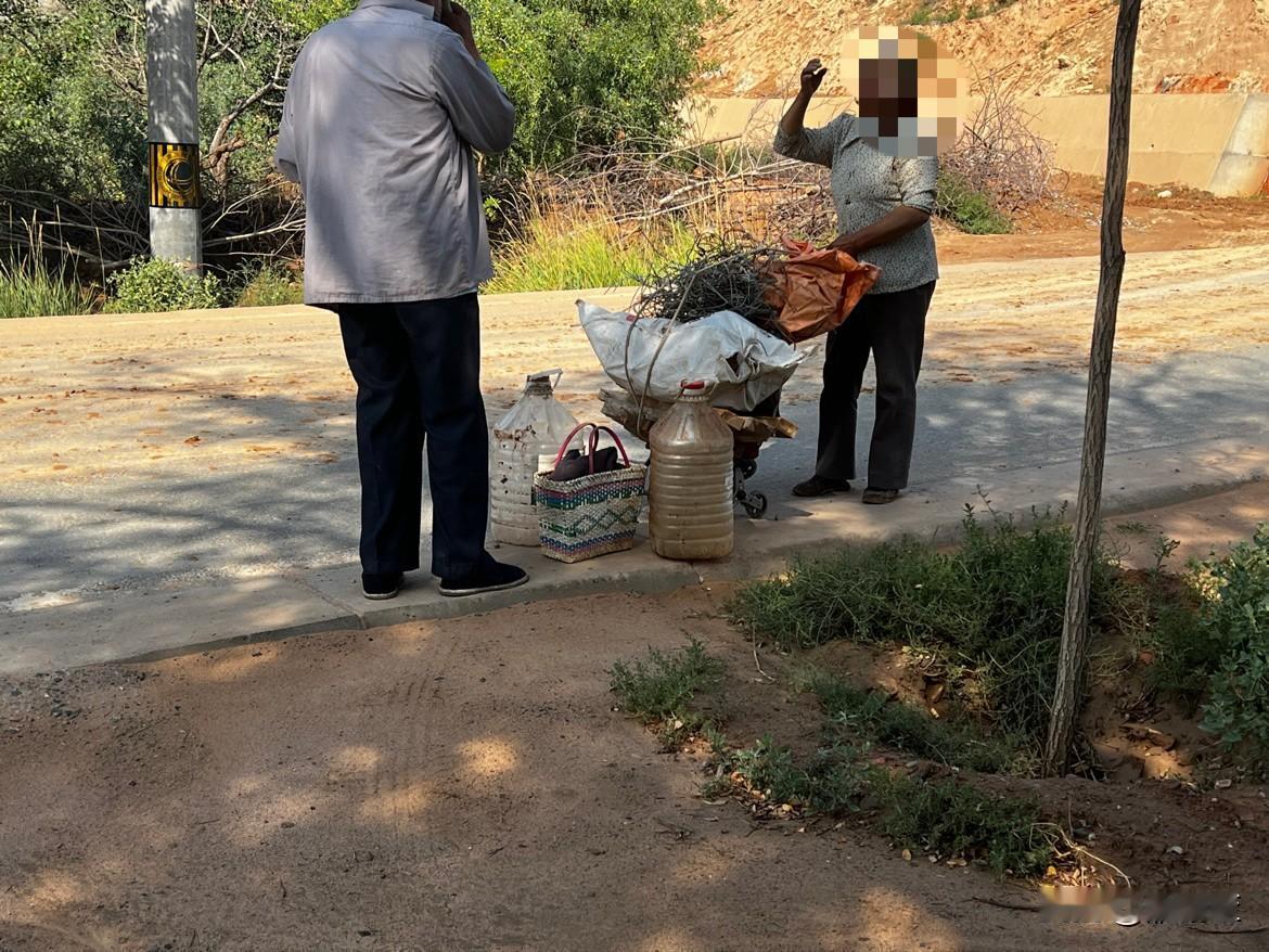 昨天开车路过兰州水墨丹霞路段，看见两个老人在30多度的天气下拉着一些破破烂烂，好