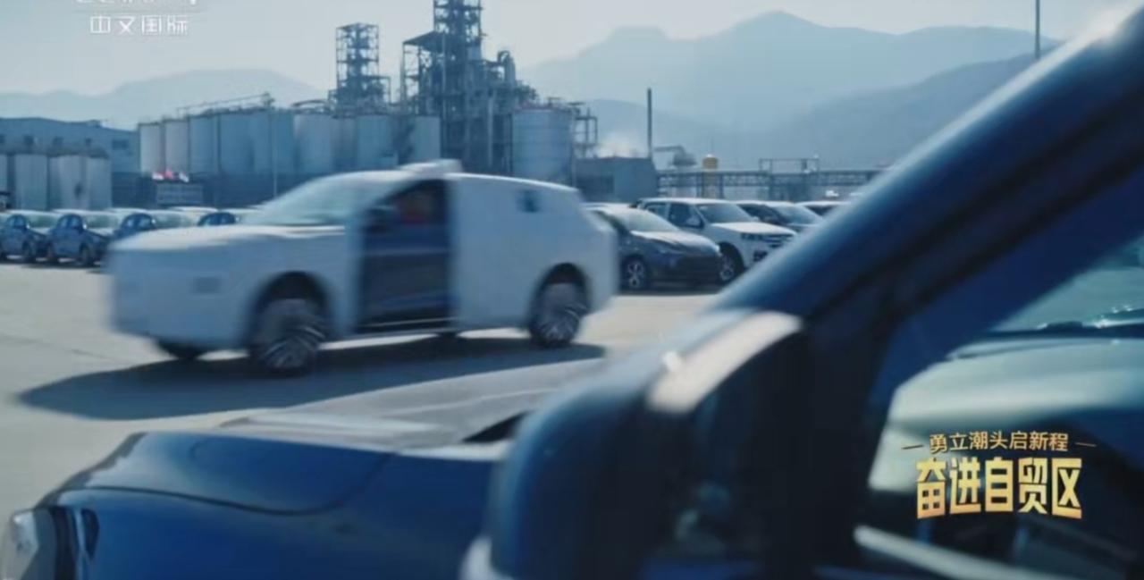 自贸试验区的汽车物流园里，车流穿梭如织，成排的车辆静待发运，外勤人员手持文件细致