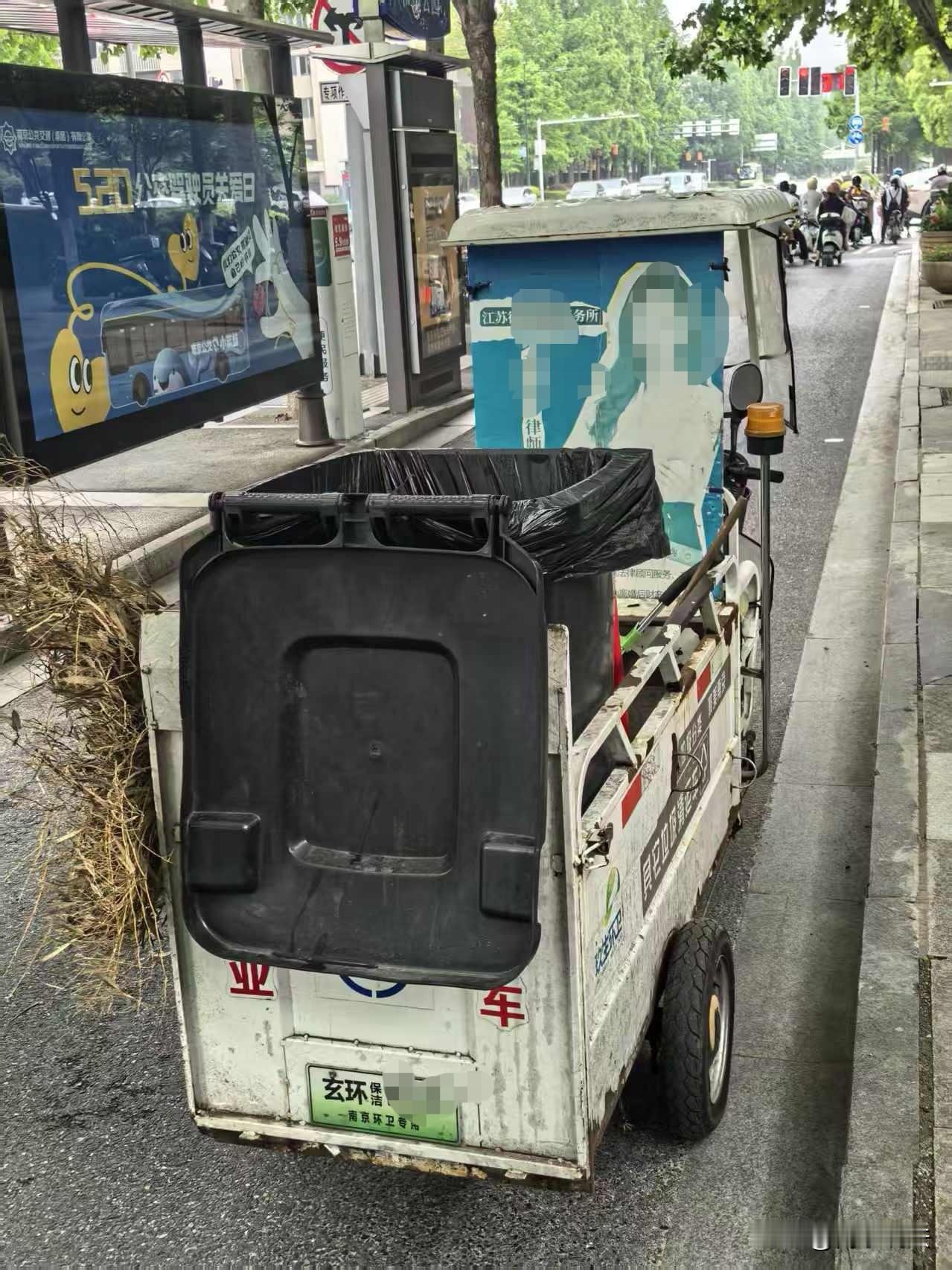 刚才我在南京鸡鸣寺一公交站旁边，看到一辆三轮清洁车上居然有律师做的广告！这位女同