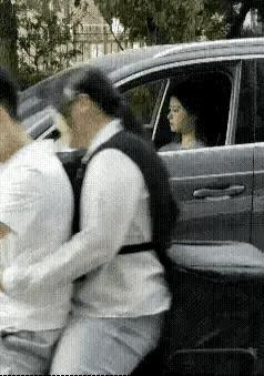 十字路口，一对情侣骑着摩托车，男司机一个急刹之后，后座的女朋友身体前倾之后，一个