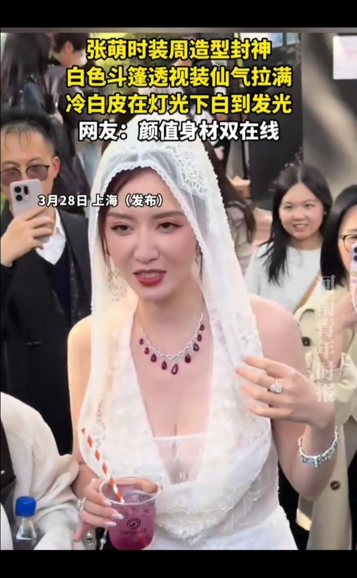 张萌时装周造型封神，白色斗篷透视装仙气拉满，冷白皮在灯光下白到发光。
网友：颜值