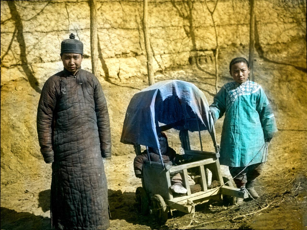 1900年代的新疆喀什，一对稚气未脱的汉族小夫妻站在路边的黄土沟里，丈夫穿着厚重