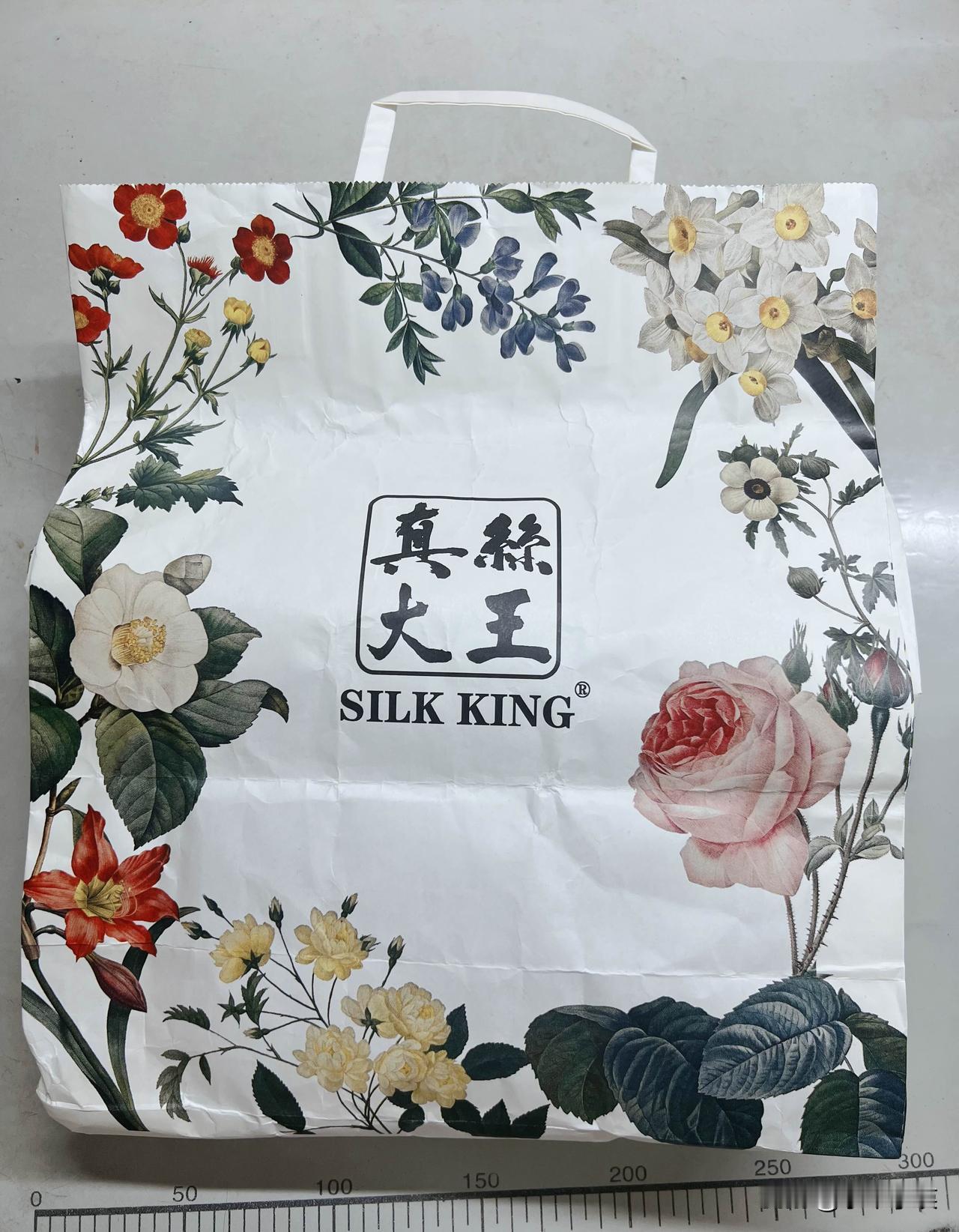 手捧着顾客寄来的这块多年前购于上海淮海路“真丝大王”的重磅真丝面料，指尖所触碰到