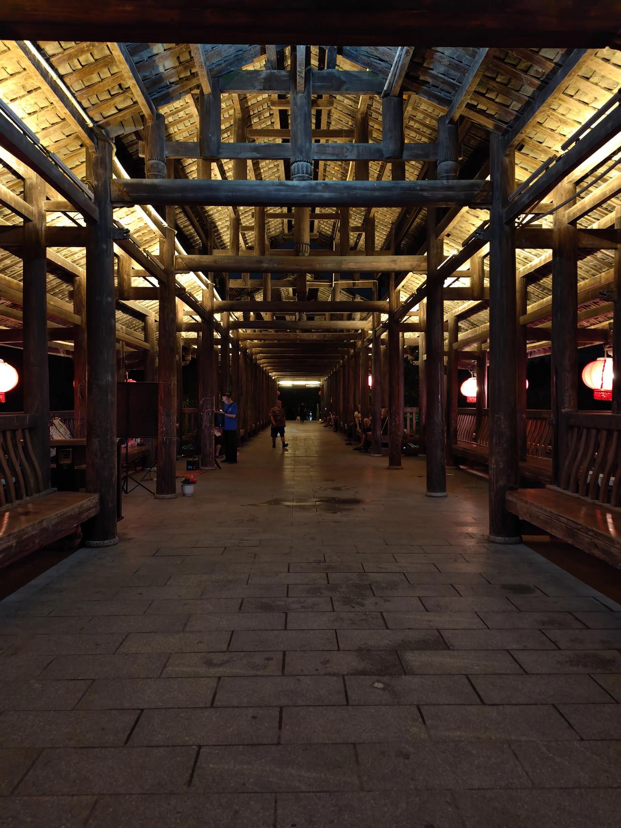 廊夜话，藏尽人间温柔
 
夜色漫过古旧木廊，粗壮木梁层层交错，原木纹理沉淀着岁月