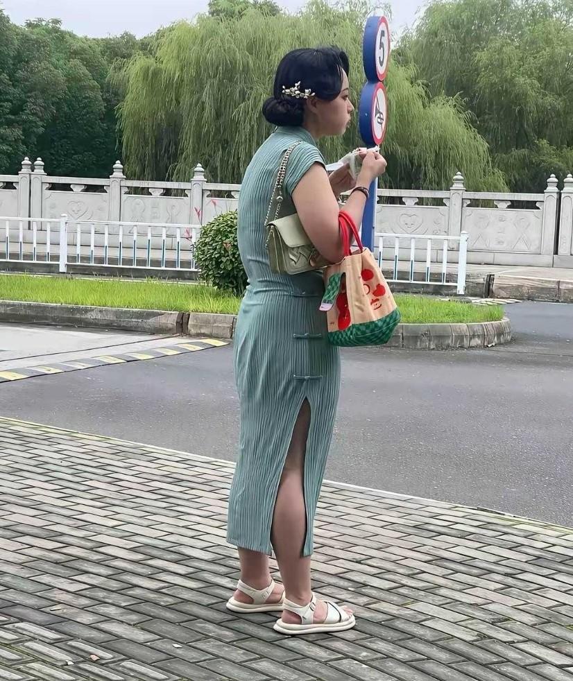 路边邂逅一位身着旗袍的美女，她这一身装扮，刹那间便让我打消了穿旗袍的念头。怎么瞧