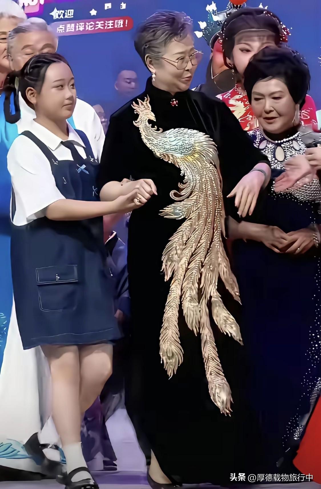 从衣服上的这只金凤凰推断，这个老太太绝对是人中“龙凤”，要不怎么能占C位呢？金绣