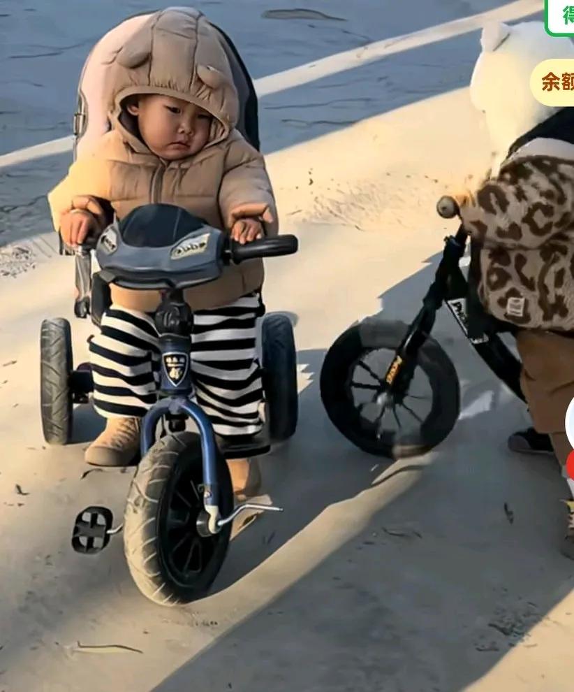 三岁孩子欺负一岁半弟弟，只见小孩不停的用自己的小车子去撞另一个小孩子的小车子，