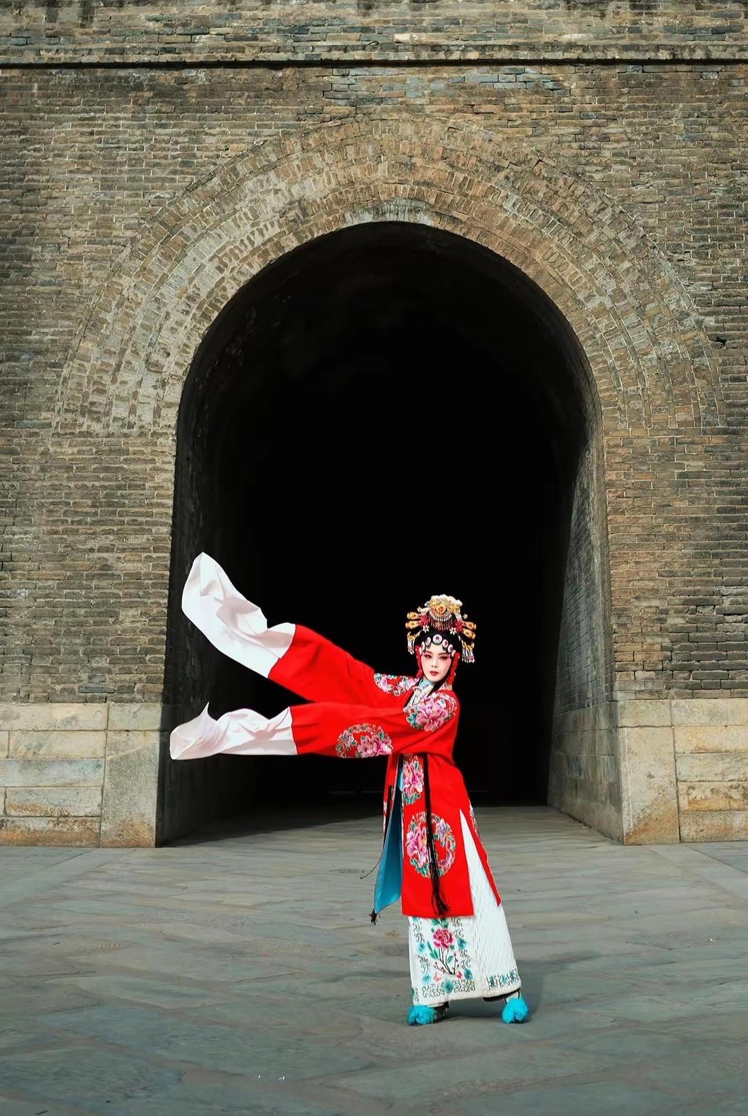 穿越千年的古典之美，红衣女子在古老城墙下翩翩起舞。