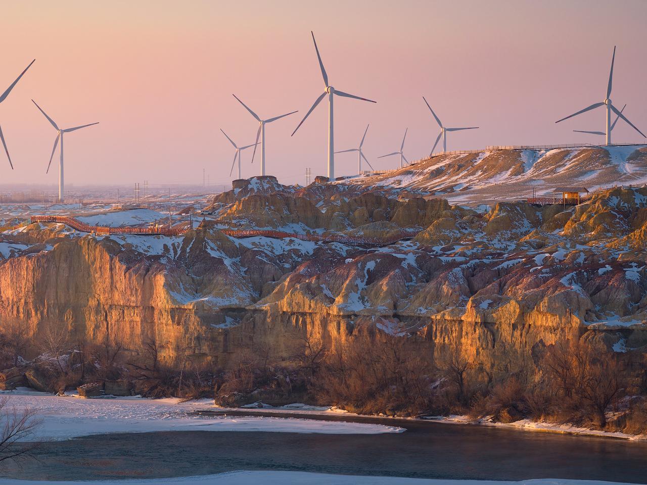 在当下的中国，你可以在各种风景地貌中见到新能源发电设施，图为新疆布尔津五彩滩景区