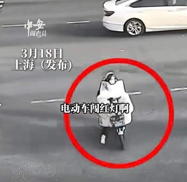 上海宝山，女子骑电动车闯红灯横穿马路，与一辆机动车相撞，女子连人带车倒地，非说自