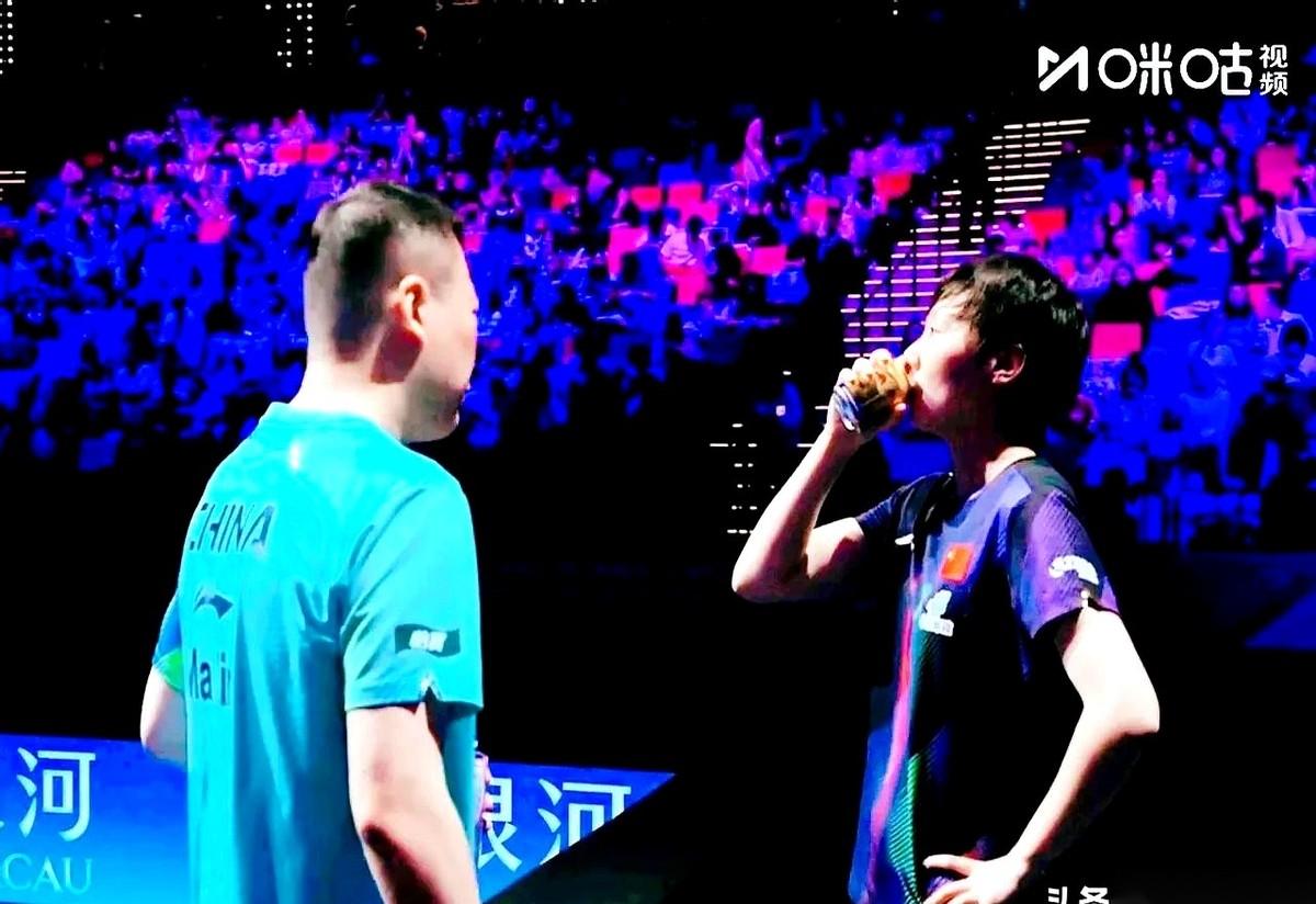 王曼昱那场球，有个镜头真把人看紧张了。
打到局间休息，教练在旁边拿着战术板比划，