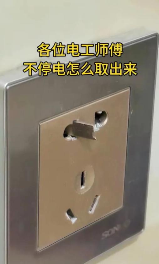插座里卡了个铁片，不停电能取出来吗？
这张图，我直接看懵了！插座的两孔里卡了个铁