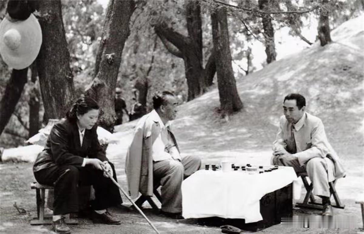 1955年摄于明十三陵，朱德与周恩来山间对弈围棋，左侧相伴的是朱德夫人康克清。山