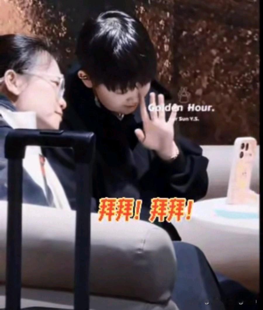 莎莎露出甜甜的笑容，看着手机，歪着头，晃动着小拳头，还挥挥小手，对着手机说“拜拜