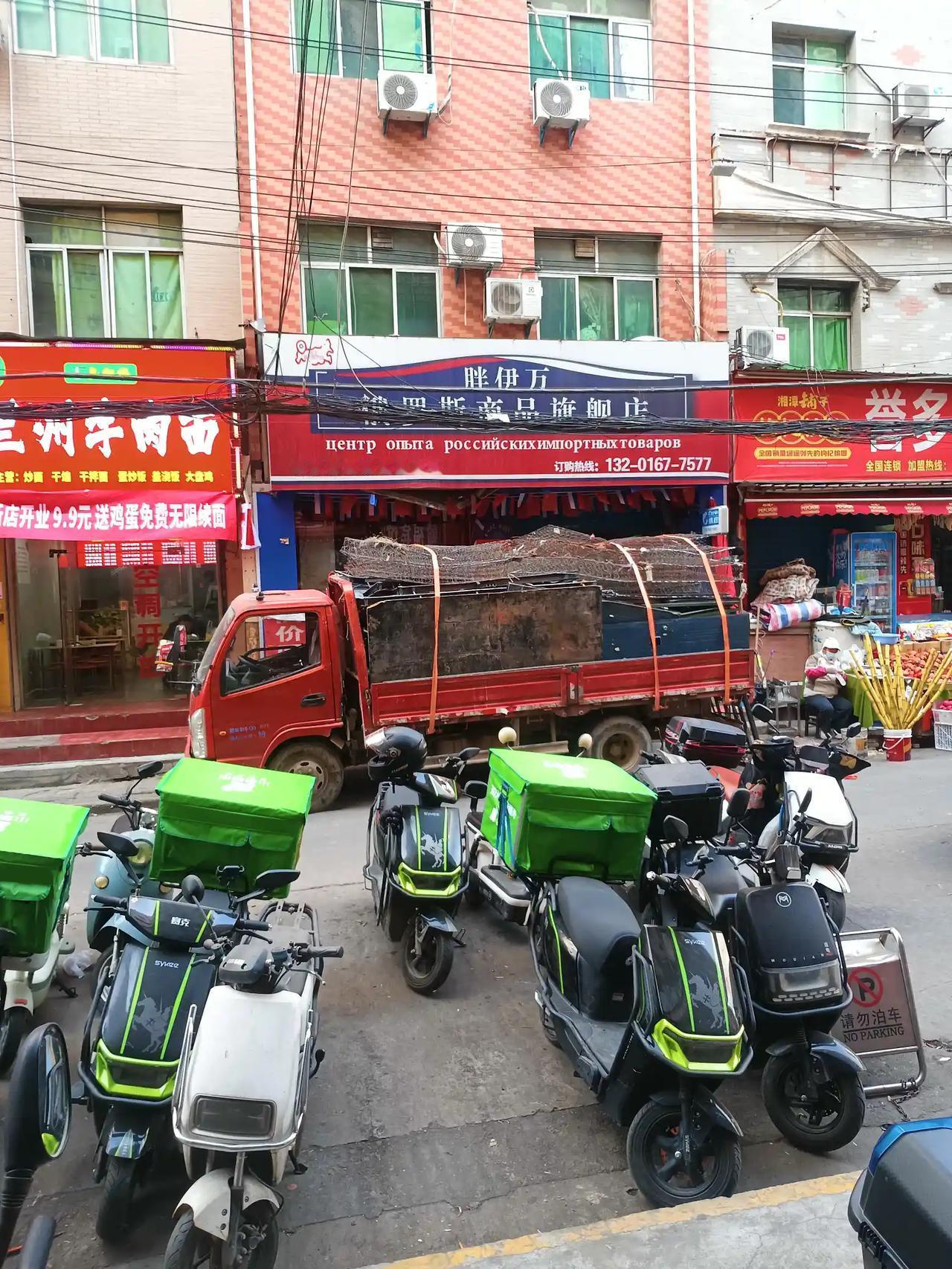 城市的大街小巷都是这种装着绿色盒子的电动车，小小的车身后座上放着一个巨大的盒子。