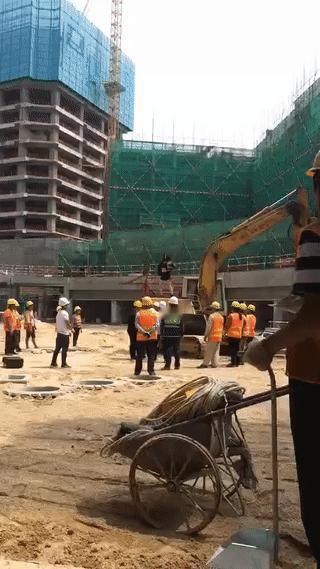 建筑工地上怎么有一名年轻女子站在挖机上大跳热辣舞蹈？
这名女子究竟是从哪里来的？