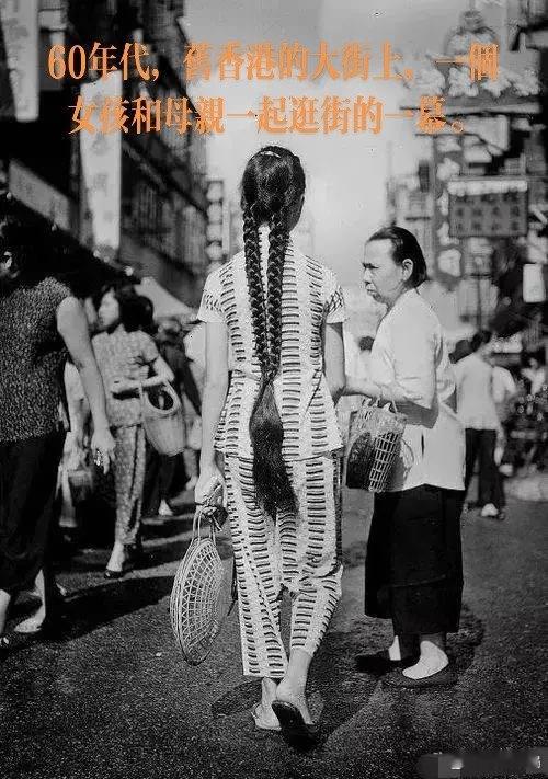 老照片里的旧时光 60年代，旧香港的大街上，一个女孩和母亲一起逛街的一幕。 