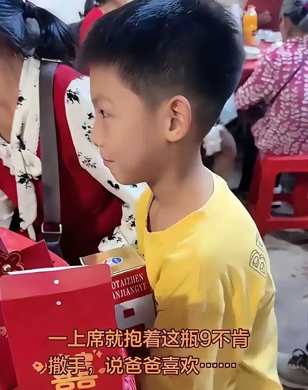 女子带自己儿子去吃酒席，结果茅台才刚上桌，她儿子直接把酒抱到怀里不撒手。同桌的人
