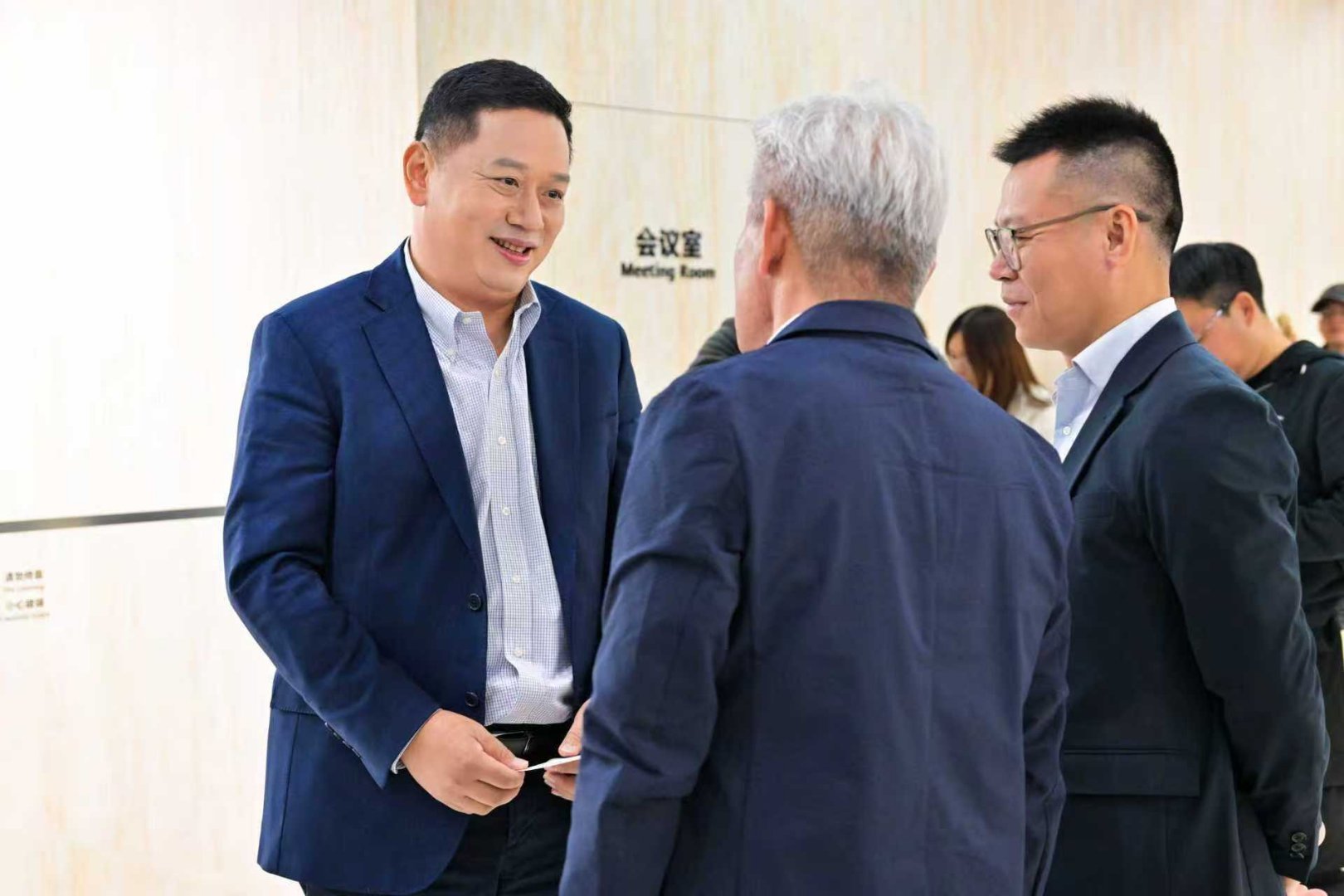 比起坐在贵宾室里等候，他更像把偌大的展馆当成了移动办公区。转身又投入下一场沟通。