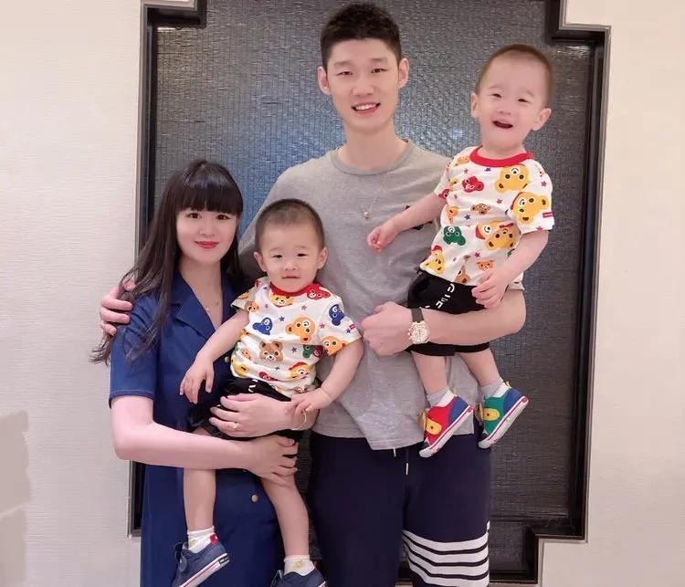 篮球运动员胡金秋一家四口的全家福合影，胡金秋是高挑个子的男运动员，长相朴实，低调