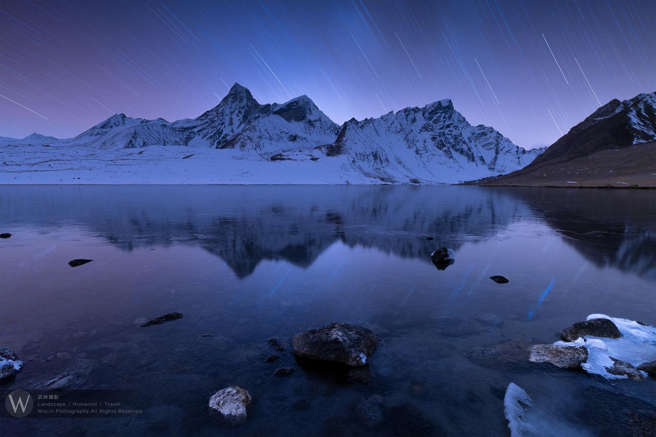 藏地星河｜夜幕漫过藏地荒原，漫天星轨拉出淡蓝长线，在渐变紫蓝的天穹舒展时光的轨迹